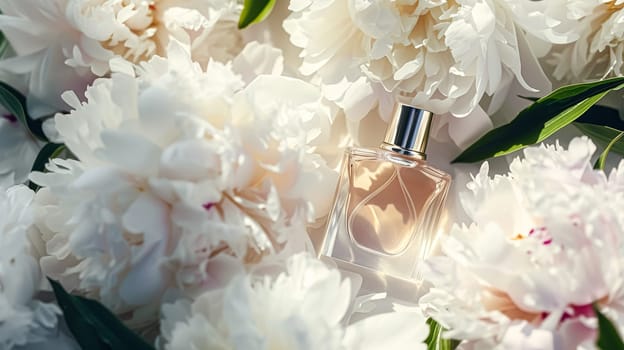 Perfume bottle with beautiful flowers. Floral background. Beauty concept. Flat lay, top view.