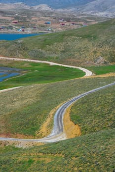 Winding mountain road surrounded by greenery on Antalya Egrigol plateau