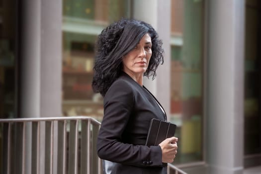 Middle Aged Caucasian Business Woman, Serious Standing With Digital Tablet In Hands Looking At Camera