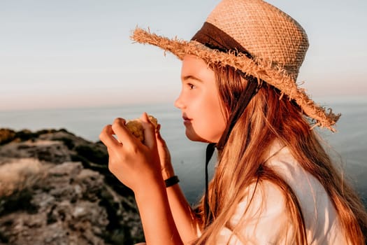 Portrait of young beautiful girl eating corn. Snacking on the sea