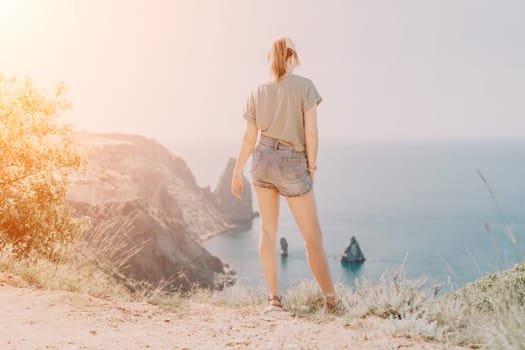 Woman travel sea. Happy carefree sensual woman with long hair in black swimwear posing at sunset beach. Silhouette of young beautiful playful positive woman outdoor. Summer vacation and trip concept