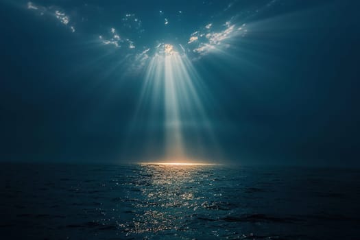 Night seascape. Bright rays of light through the clouds illuminate the sea at night.