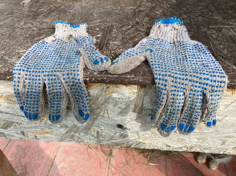 Construction gloves hanging from a the  table