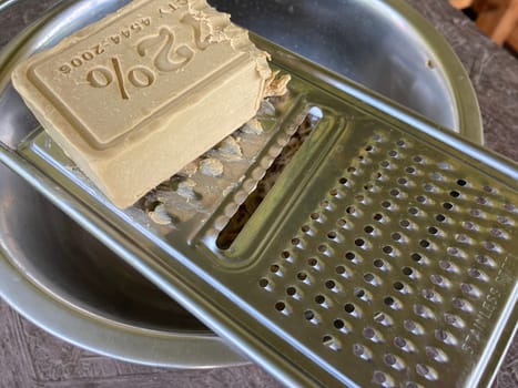 Grating laundry soap on a the food grater
