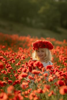 A young girl is standing in a field of red poppies. She is wearing a red headband and holding a red flower. The scene is peaceful and serene