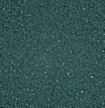 Background texture of wet asphalt road with roughness and relief irregularity of gray color close-up from above