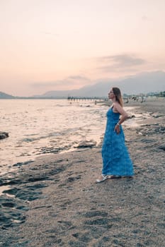 Woman sits on the beach and looks at the sea in Alanya city, Turkey. Travelling or vacation concept