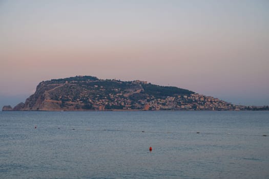 Beautiful sunrise scene on Alanya beach with view to famous Alanya island, in Turkey