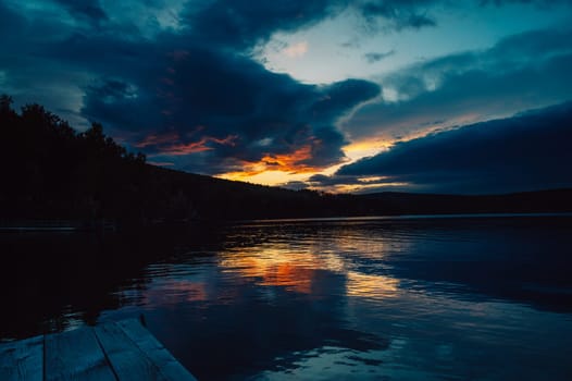 A calm and silent evening at sunset at the summer lake