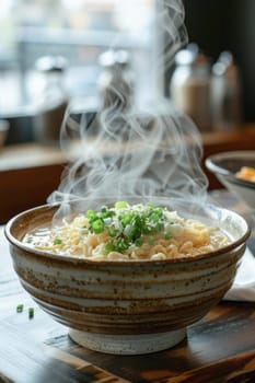 A steaming bowl of noodles on a table showcasing the art of food preparation and culinary experience