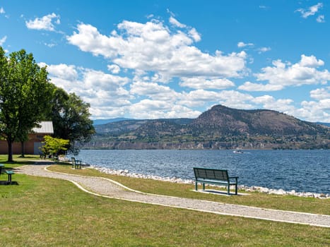 Scenery Okanagan lake overview with the bench at the pathway along the waterfront