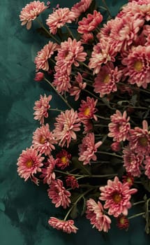 Chrysanthemum flowers on a green, textured background.