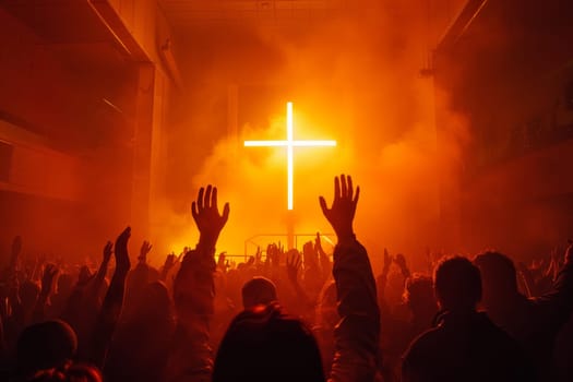 A large crowd of christian people are gathered in a church, with their hands raised in the air and a large cross in the center of the room. The atmosphere is one of worship and unity