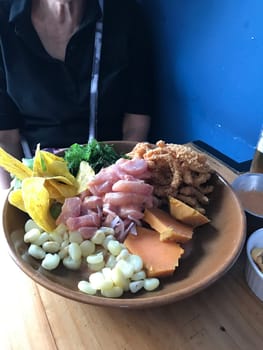 Exquisite traditional peruvian ceviche dish with marinated seafood. Fried calamari. Raw fish. Sweet potato. And plantain chips