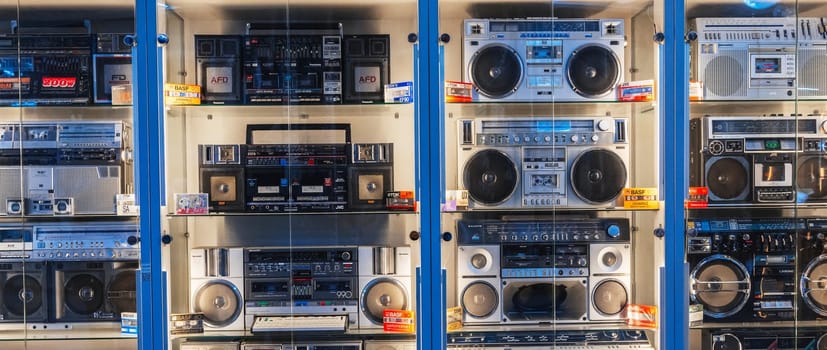 various classic Japanese vintage cassette recorders, portable boomboxes and tape audio cassettes on the museum shelf. Tashkent, Uzbekistan - April 16, 2024