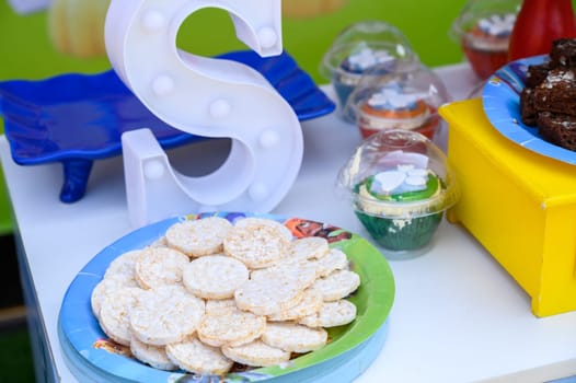 Close-up view of a festive snack table with cookies and decorations at a children's party