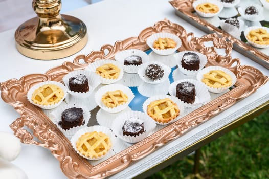 Delicious selection of bite-sized desserts beautifully displayed on a decorative tray for an event