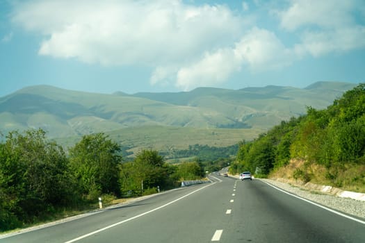 View from the car of an asphalt road in the mountainous area of Dagestan.