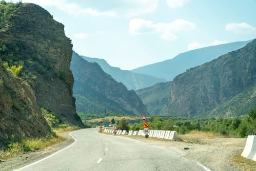 View from the car of an asphalt road in the mountainous area of Dagestan.