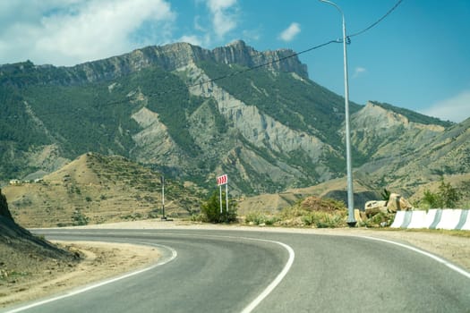 View from the car of an asphalt road in the mountainous area of Dagestan.