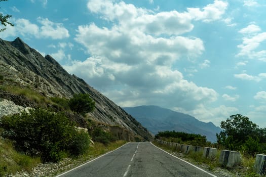 View from the car of an asphalt road in the mountainous area of Dagestan.