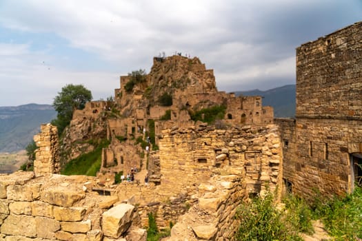 Dagestan Gamsutl. Ancient ghost town of Gamsutl old stone houses in abandoned Gamsutl mountain village in Dagestan, Abandoned etnic aul, summer landscape