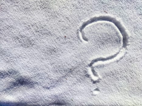 A large question mark is etched into the fresh snow, creating a stark contrast against the white surface on a serene winter morning.