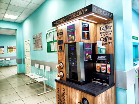 Kirov, Russia - May 21, 2024: A coffee vending machine is located in a public institution waiting area, offering a variety of coffee options