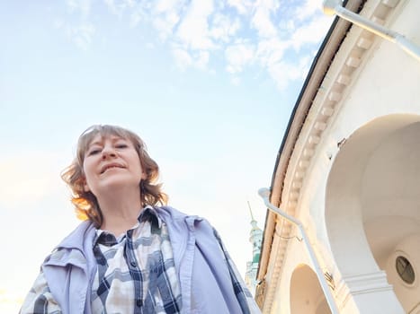 Portrait of middle-aged woman taking selfies in the city. Women's travel tourism. The blogger poses