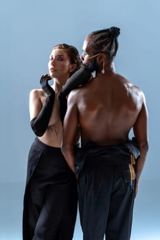 Shirtless gay man and woman with makeup posing on blue background. Studio shot of two LGBT individuals. Life is beautiful with your bestie by your side. Embracing the concept of gender equality.