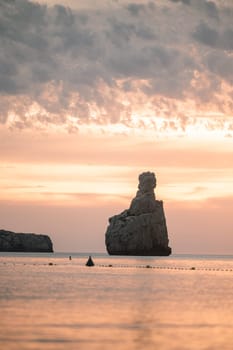 Sunset on Benirras beach in Ibiza in summer.