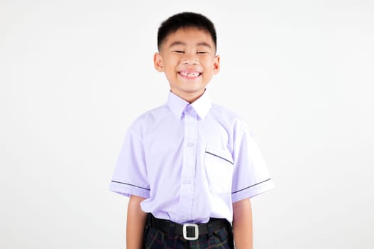 Portrait smile Asian little boy primary posing studio isolated white background, happy cute man kid wear school uniform plaid, back to school concept