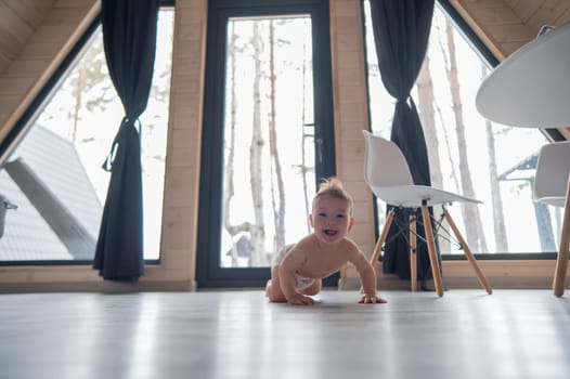 Little boy crawling on the floor by the patio window