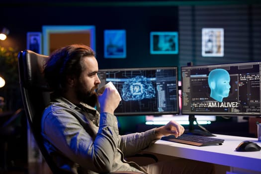 Programmer drinking coffee, chatting with awaken AI gaining consciousness on computer. Relaxed man enjoying hot beverage, communicating with artificial intelligence through desktop PC