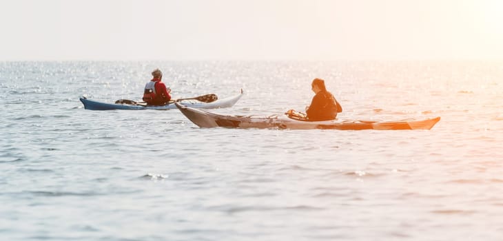 Happy smiling woman in kayak on ocean, paddling with wooden oar. Calm sea water and horizon in background