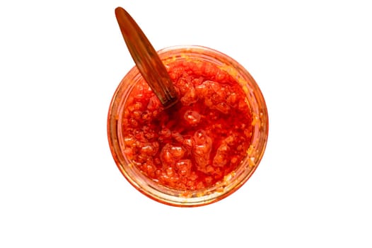 Homemade canned red pepper sauce on an isolated white background