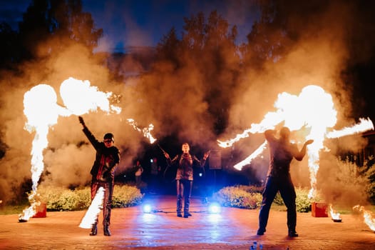 SEMIGORYE, RUSSIA - JUNE 17, 2022: Fire show at night at the festival event. A team of people arrange a sparkling performance