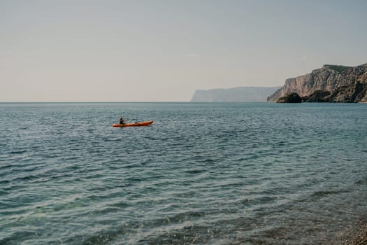 Kayak sea woman. Happy attractive woman with long hair in red swimsuit, swimming on kayak. Summer holiday vacation and travel concept