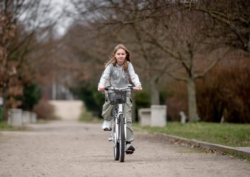 Warm Weather Sees Girl Riding Bicycle Through Spring Park