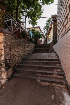 beautiful narrow alley with stone trim and facades of buildings in the Crimea In Gurzuf