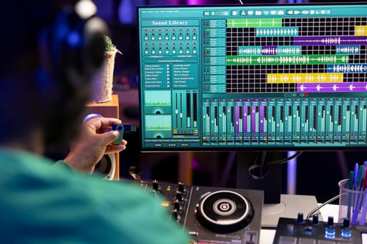 Artist composing new music with an usb stick in his home studio, editing songs from old audio recordings. Skilled songwriter producer mixing and mastering soundtracks, production software.