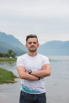 Man portrait on Teletskoye lake in Altai mountains, Siberia, Russia. Beauty summer day.