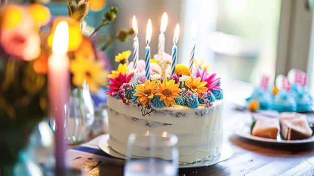 Birthday cake with candles and flowers on the table. Selective focus.