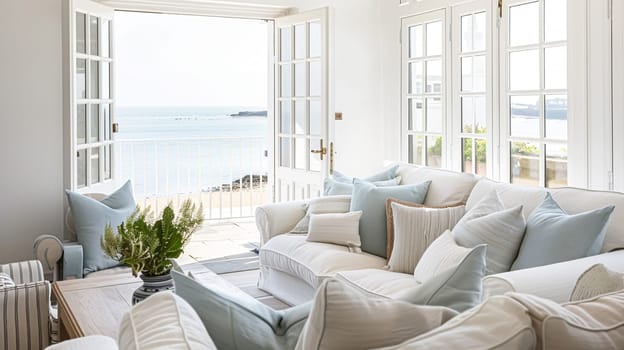 Interior of a living room with white walls, sofa and cushions. Sitting room in coastal cottage with sea view. Luxury lounge room