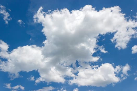 Fluffy curly large white cloud against the blue summer sky.