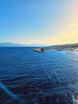 The ferry boat is staying in the pier sea mountains Split sunny day sunlight . High quality photo. Mobile photo vertical photo