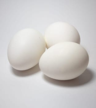 A group of white eggs on a white table. Healthy diet concept. Main ingredient for baking cakes.