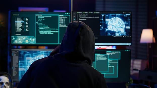 Cybercriminal using AI machine learning to develop zero day exploit undetectable by antivirus software. Hacker using artificial intelligence technology to build script tricking firewalls, camera B