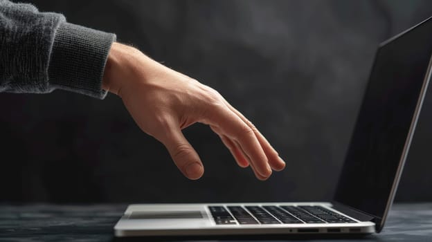 Connection through Technology, A Hand Reaching Out to Laptop in the Dark.