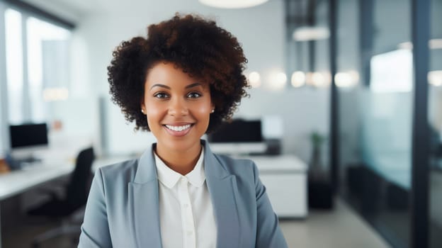 Portrait of confident happy smiling african businesswoman standing in the office, black female entrepreneur wearing business suit looking at camera